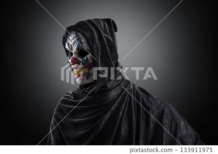 Portrait of a scary clown over dark misty background with clipping path 133911975
