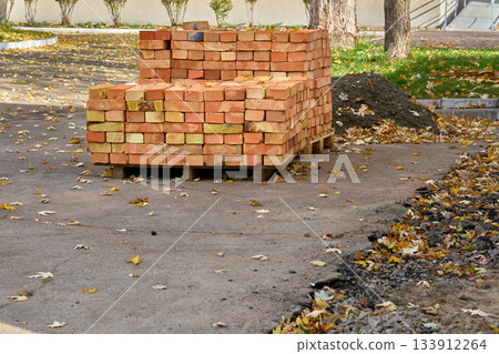 Stacked bricks on a wooden pallet,ready for construction Stacked bricks on a wooden pallet,ready for construction 133912264