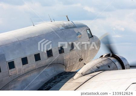 Close-up oldtimer piston-engined passenger aircraft at the airport 133912624