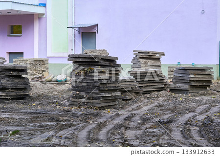 Road works.Old concrete paving slabs stacked for cleaning Road works.Old concrete paving slabs stacked for cleaning 133912633