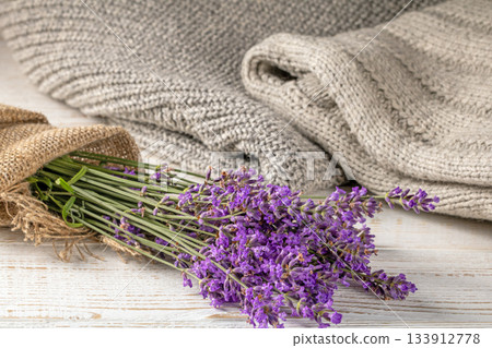 Beautiful lavender bouquet displayed against a cozy knitted background Beautiful lavender bouquet displayed against a cozy knitted background 133912778