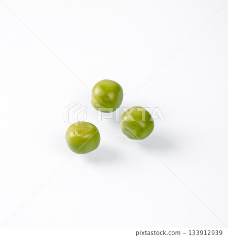 Close-up of three fresh green peas on a clean white background 133912939