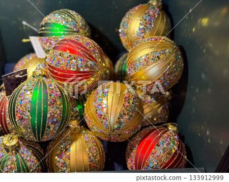 Glittering multicolor Christmas ornaments. Holiday sparkle, festive richness and luxurious seasonal mood. Glittering multicolor Christmas ornaments. Holiday sparkle, festive richness and luxurious seasonal mood. 133912999