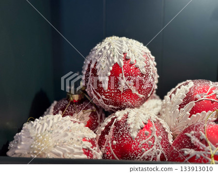 Christmas Red frosted ornaments with white winter detailing arranged in a festive display. Seasonal beauty, decorative elegance and joyful holidays charm shaping magical holiday atmosphere and vibrant Christmas Red frosted ornaments with white winter detailing arranged in a festive display. Seasonal beauty, decorative elegance and joyful holidays charm shaping magical holiday atmosphere and vibrant 133913010