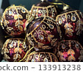 Ornate burgundy Christmas baubles with gold detail. Holiday luxury, seasonal artistry and elegant decoration. 133913238