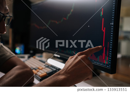 Close-up hands of trader male looking at stock market financial charts on computer screen, analyzing falling prices and market crash data, experiencing business crisis and loss trading online. Close-up hands of trader male looking at stock market financial charts on computer screen, analyzing falling prices and market crash data, experiencing business crisis and loss trading online. 133913551