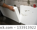 builder installs polystyrene foam sheets 133913922