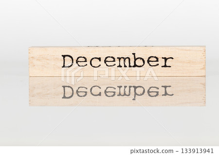 a wooden cube with an inscription December on a white background 133913941