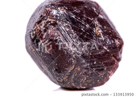 Macro of a mineral garnet stone on a white background Macro of a mineral garnet stone on a white background 133913950