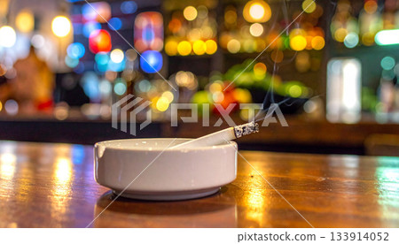 Cigarette Smoldering in Ashtray at Bar Cigarette Smoldering in Ashtray at Bar 133914052