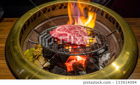 Grilling Wagyu Beef on a Charcoal Grill 133914094
