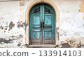 Old Weathered Blue Door in Stone Wall 133914103
