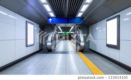 Empty Subway Station with Escalators and Signage 133914105
