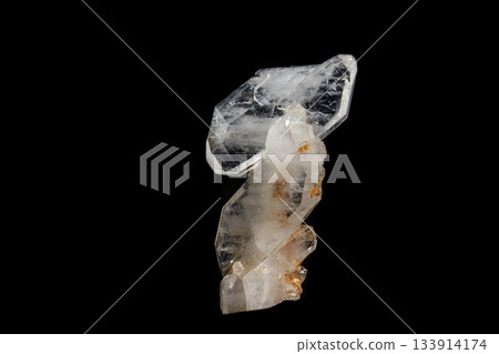 Macro mineral stone Flattened crystal of rock crystal on a black background Macro mineral stone Flattened crystal of rock crystal on a black background 133914174