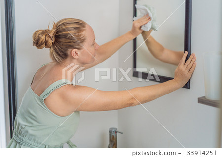 Woman cleaning her home, organizing and tidying the living space with a calm and focused mood. Home care, cleanliness and lifestyle concept, representing routine, wellbeing, productivity and Woman cleaning her home, organizing and tidying the living space with a calm and focused mood. Home care, cleanliness and lifestyle concept, representing routine, wellbeing, productivity and 133914251
