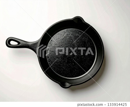 Culinary preparation. Cast iron pan. Kitchenware on white background. Top view. 133914425
