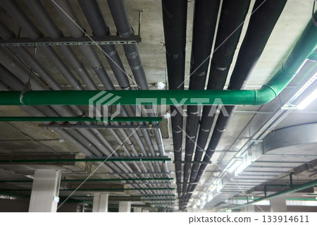 Subterranean parking details, Basement parking area equipped with lighting and plumbing, Underground vehicle shelter featuring electrical wiring and ventilation systems Subterranean parking details, Basement parking area equipped with lighting and plumbing, Underground vehicle shelter featuring electrical wiring and ventilation systems 133914611