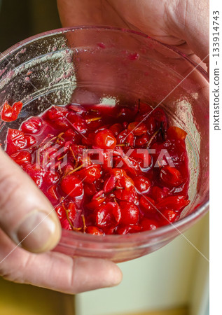 Hands Holding Bowl of Crushed Red Berries Hands Holding Bowl of Crushed Red Berries 133914743