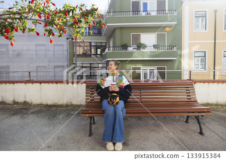 Woman enjoys peaceful moment in bustling city environment during midday 133915384