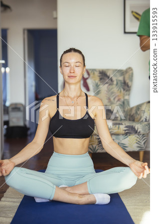 relaxed woman engaging in silent meditation surrounded by calming light and cozy environment 133915593