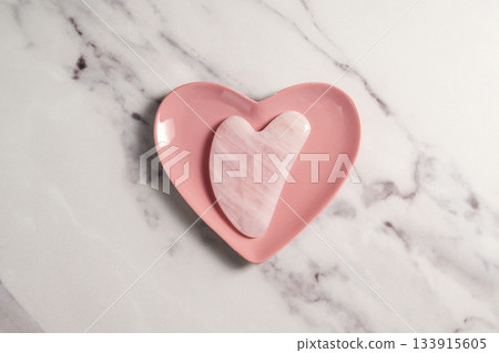 Rose quartz gua sha tool face massage tool, beauty abstract photo Rose quartz gua sha tool face massage tool, beauty abstract photo 133915605