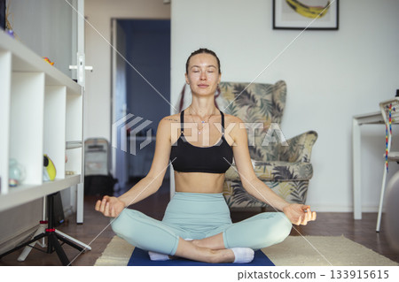 calm woman practicing mindful meditation, tranquil setting showing woman practicing calm mindfulness 133915615