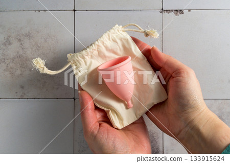 Menstrual cup. Pink feminine hygiene product. Women health concept. 133915624