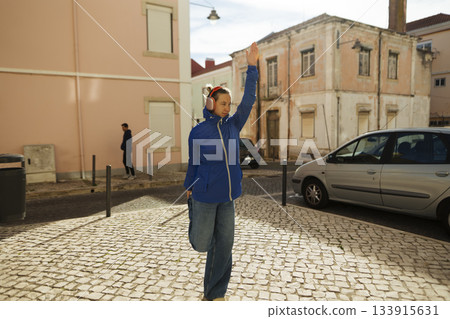 Individual in vibrant clothing requests transportation on city street Individual in vibrant clothing requests transportation on city street 133915631