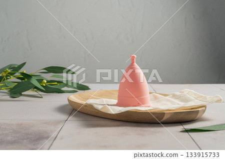 Menstrual cup. Pink feminine hygiene product. Women health concept. Menstrual cup. Pink feminine hygiene product. Women health concept. 133915733