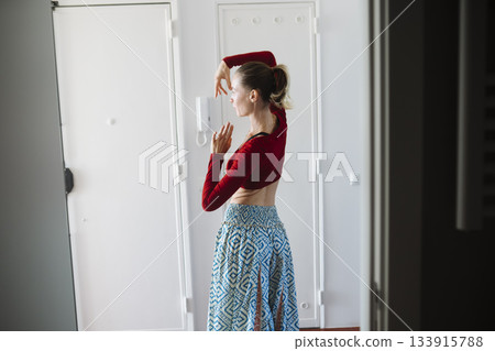 Quiet preparation with natural sunlight illuminating her space Quiet preparation with natural sunlight illuminating her space 133915788