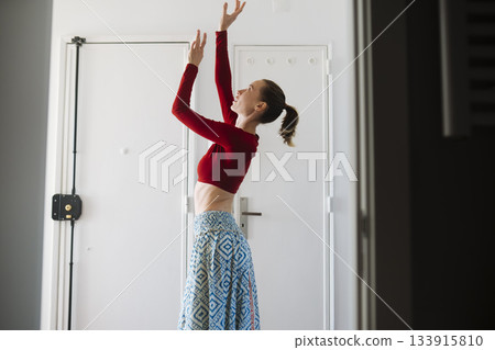 Elegant woman prepares confidently with steady focus indoors 133915810