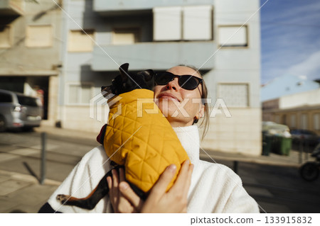 Casual winter fashion showing joyful pet affection outdoors 133915832