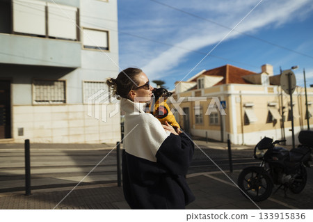 Energetic individual strolling city streets with small pet companion Energetic individual strolling city streets with small pet companion 133915836