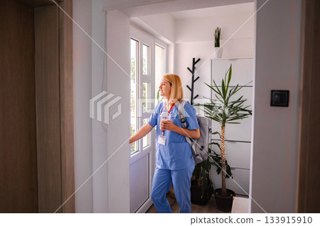 Female Doctor Leaving Home After Work, Holding a Refreshing Drink Female Doctor Leaving Home After Work, Holding a Refreshing Drink 133915910