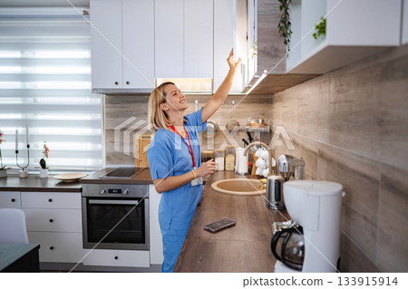 Nurse taking a break in the kitchen and grabbing a mug 133915914