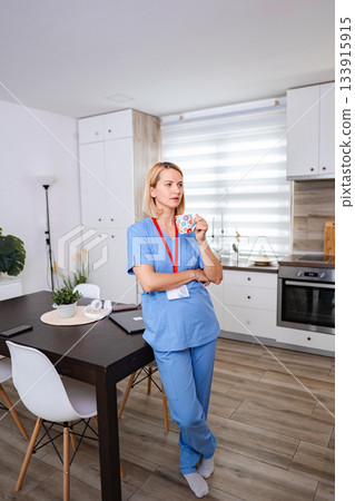 Female Doctor Drinking Coffee During Work Break at Home Female Doctor Drinking Coffee During Work Break at Home 133915915
