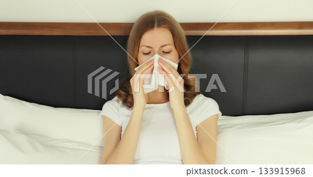 Sick exhausted young woman sneezing blow nose using tissue, unhealthy suffering girl feels unwell Sick exhausted young woman sneezing blow nose using tissue, unhealthy suffering girl feels unwell 133915968