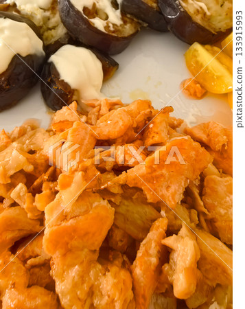 Delicious salmon dish served with roasted eggplant and fresh vegetables Delicious salmon dish served with roasted eggplant and fresh vegetables 133915993