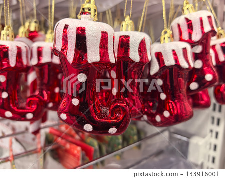 Colorful holiday ornaments hang in a festive display at a local store Colorful holiday ornaments hang in a festive display at a local store 133916001