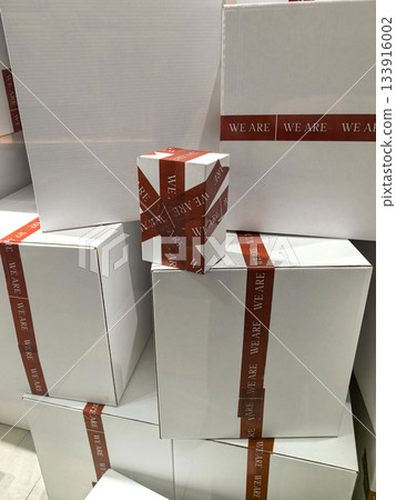 Creative display of gift boxes with bold red ribbons in a festive setting Creative display of gift boxes with bold red ribbons in a festive setting 133916002