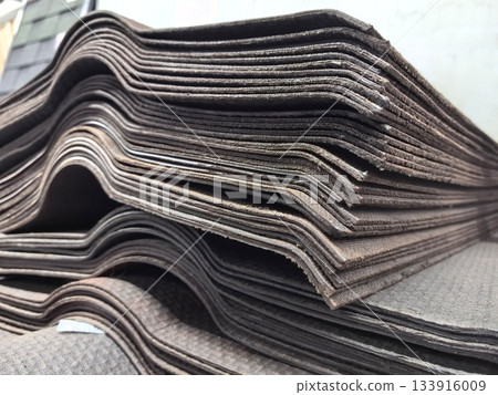 Stacked slate roofing materials ready for installation at a construction site Stacked slate roofing materials ready for installation at a construction site 133916009