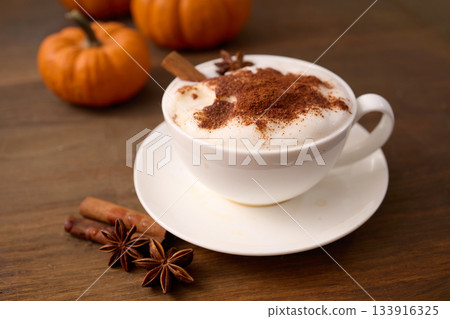 Pumpkin Spice Latte. A cozy pumpkin spice latte with cinnamon served in a white cup 133916325