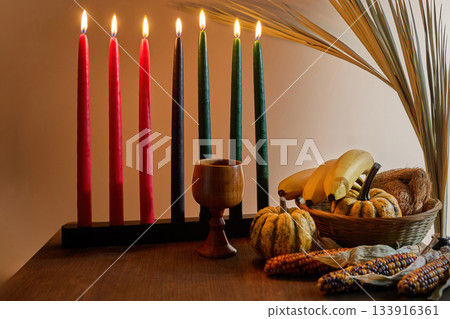 Kwanzaa Table Setting. A festive Kwanzaa display with Kinara, fruits, and vegetables Kwanzaa Table Setting. A festive Kwanzaa display with Kinara, fruits, and vegetables 133916361