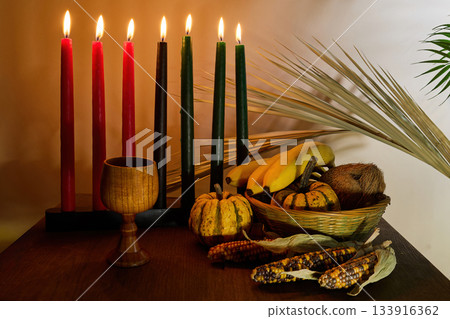 Kwanzaa Celebration Setting. A warm display of Kwanzaa candles, gourds, corn, and fruit 133916362