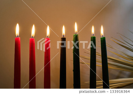 Kwanzaa Candles. Lit Kwanzaa candles in red, black, and green symbolize unity and celebration. Kwanzaa Candles. Lit Kwanzaa candles in red, black, and green symbolize unity and celebration. 133916364