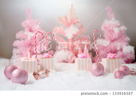 Pink Winter Wonderland. A festive scene with pink trees, gifts, and candy canes Pink Winter Wonderland. A festive scene with pink trees, gifts, and candy canes 133916387