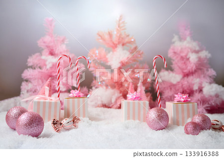 Pink Winter Wonderland. A festive scene with pink trees, gifts, and candy canes Pink Winter Wonderland. A festive scene with pink trees, gifts, and candy canes 133916388