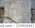 Ancient stone column with inscriptions and hieroglyphs. Antique landmark. Turkey, Kemer, Phaselis 133916441