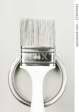 Paintbrush handle standing on paint can lid. Color of 2026 year dancer in the white cloud Paintbrush handle standing on paint can lid. Color of 2026 year dancer in the white cloud 133916461