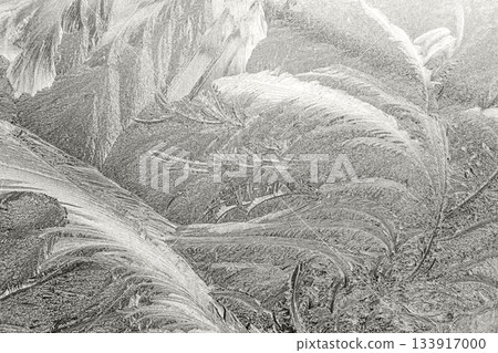 Intricate frost patterns detailed on a window during a cold winter morning 133917000